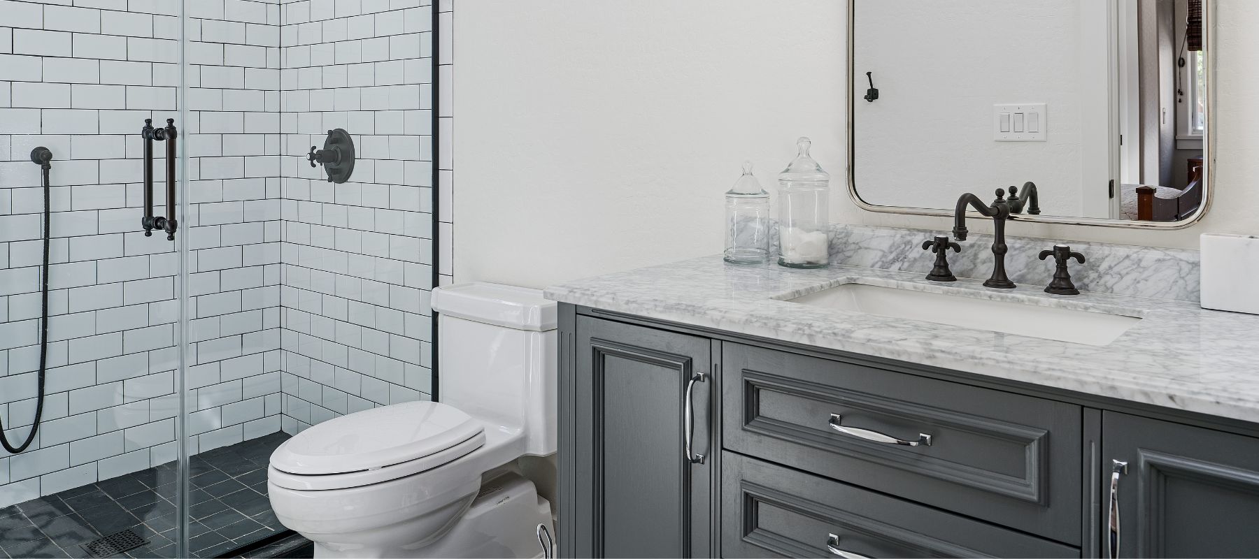 a toilet in between a shower and a sink in a residential bathroom