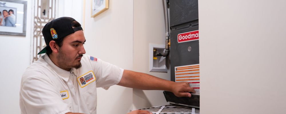 Kahuna Comfort technician performing a professional furnace installation and safety check.